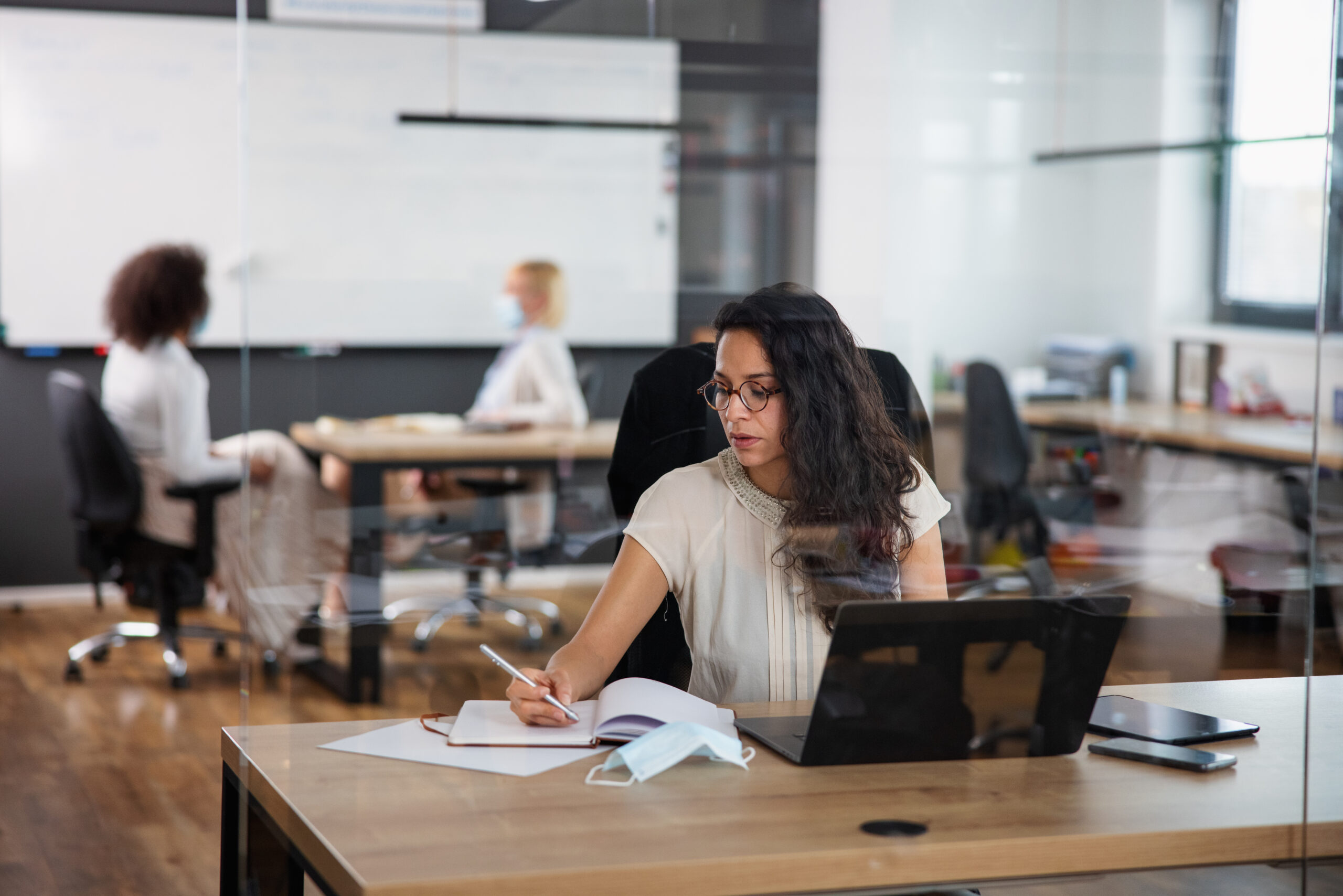 Hispanic Businesswoman Wearing Eyeglasses And Working In The Office
